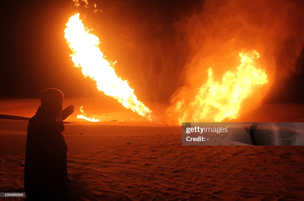 An Egyptian man looks at flames rising f