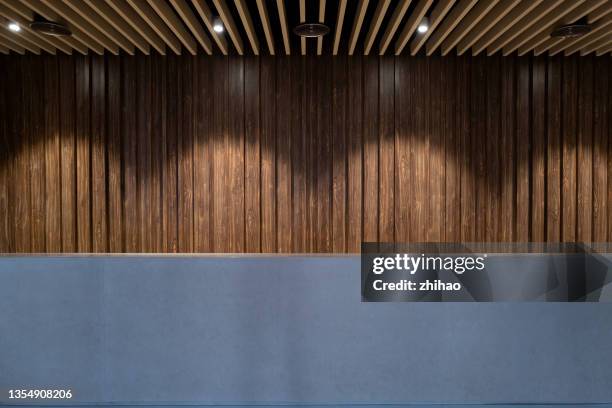lobby desk with wooden wall - wood desk stock pictures, royalty-free photos & images