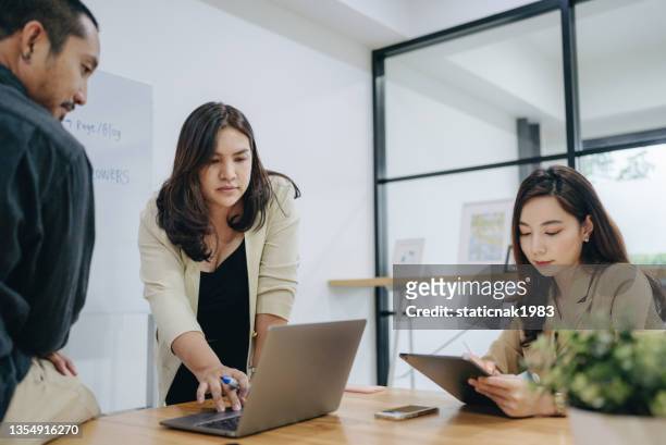 business people discussing with team after work - southeast asia office stock pictures, royalty-free photos & images