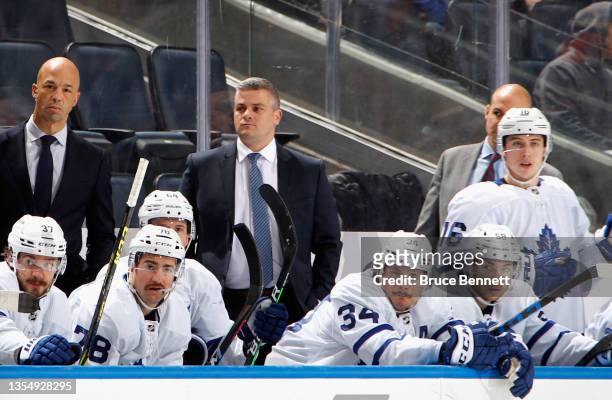 Head coach Sheldon Keefe of the Toronto Maple Leafs tends to the bench during the first period against the New York Islanders at the UBS Arena on...