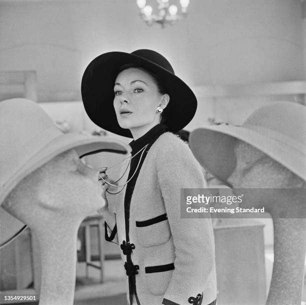 Fashion model Barbara Ann Taylor wearing a hat with a wide brim, UK, 6th July 1964.