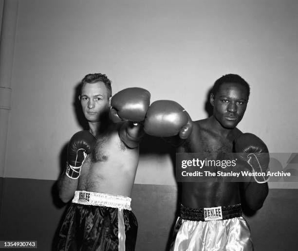 New York, NY Photo shows Charlie Norkus and Ezzard Charles posing for the camera prior to their Heavyweight bout at Madison Square Garden, New York,...