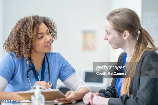 nurse meeting with a patient - young adult at doctor stock pictures, royalty-free photos & images