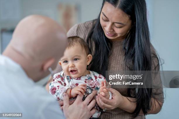 mother and daughter at the doctors - doctor and baby stock pictures, royalty-free photos & images