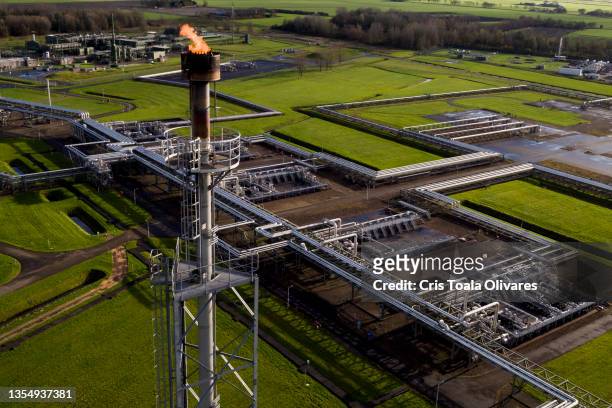 An aerial view of a natural gas extraction plant and pipework above ground at an onshore site operated by Nederlandse Aardolie Maatschappij BV on...