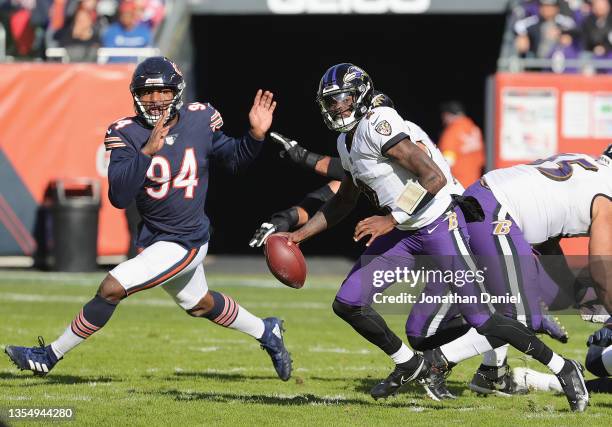 Tyler Huntley of the Baltimore Ravens is chased by Robert Quinn of the Chicago Bears at Soldier Field on November 21, 2021 in Chicago, Illinois. The...