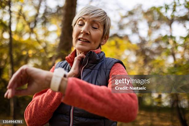 woman checking her pulse after exercise - carotid pulse stock pictures, royalty-free photos & images