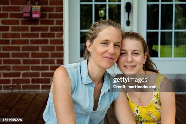 real family portrait of mother and teenage daughter on home porch in summer. - teenage daughter stock pictures, royalty-free photos & images