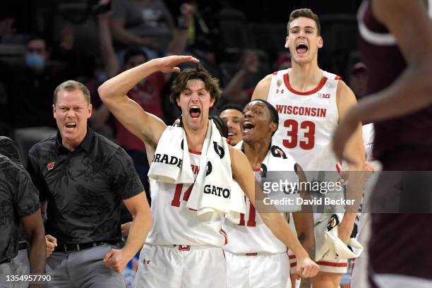 The Wisconsin Badgers bench cheers after a three-point basket against the Texas A&M Aggies during the 2021 Maui Invitational basketball tournament at...