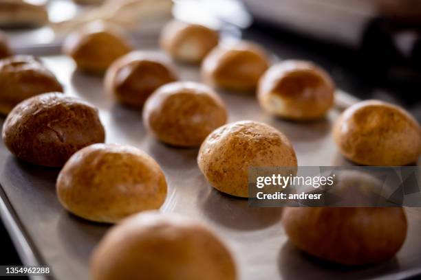 close-up on freshly baked buns at the bakery - baking bread stock pictures, royalty-free photos & images