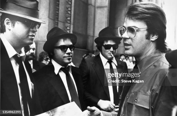 Canadian comedian Day Aykroyd greets a group of unidentified people, dressed as his 'Blues Brothers' character, outside City Hall, Chicago, Illinois,...