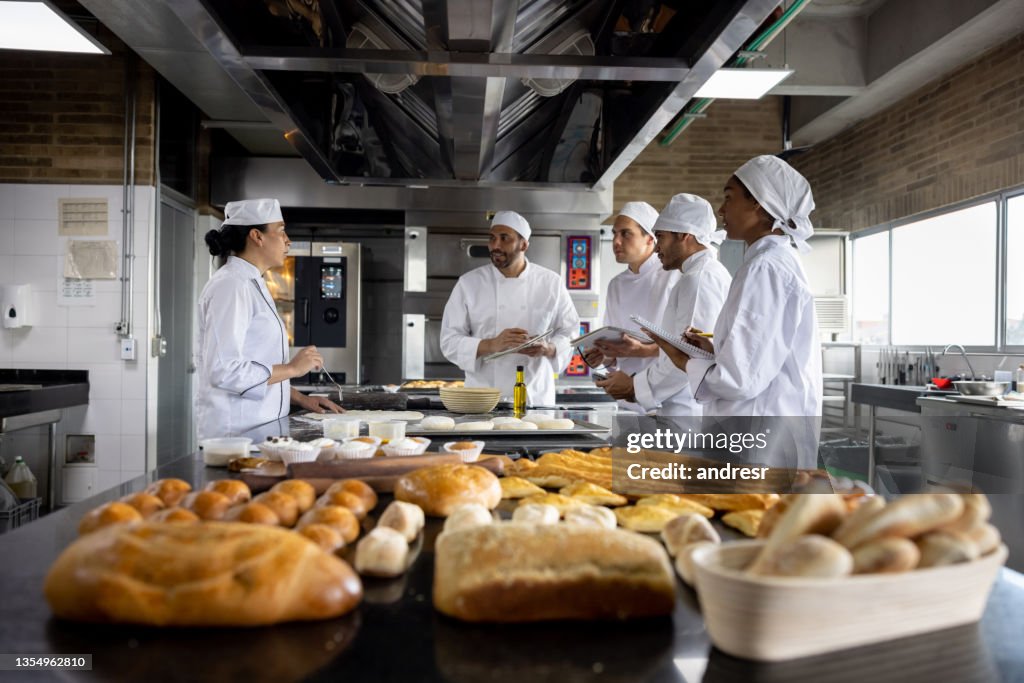 Teacher in a baking class explaining to her students how to make bread