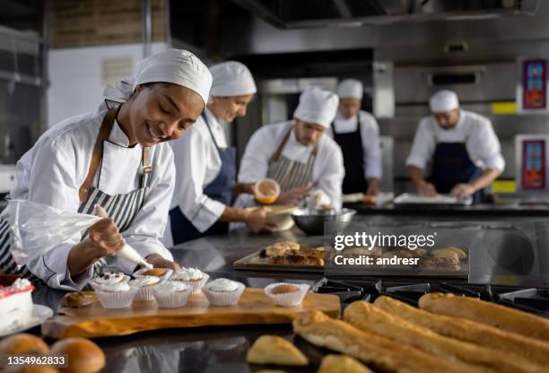 happy team working at a bakery making pastries - bakning business bildbanksfoton och bilder