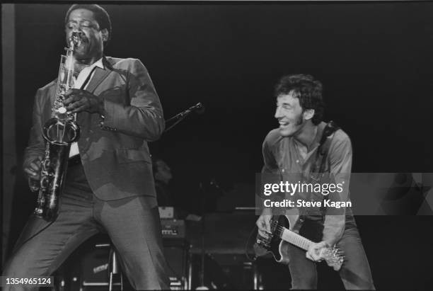 American Rock musicians Clarence Clemons , on saxophone, and Bruce Springsteen, on guitar, perform onstage at the Uptown Theatre, Chicago, Illinois,...
