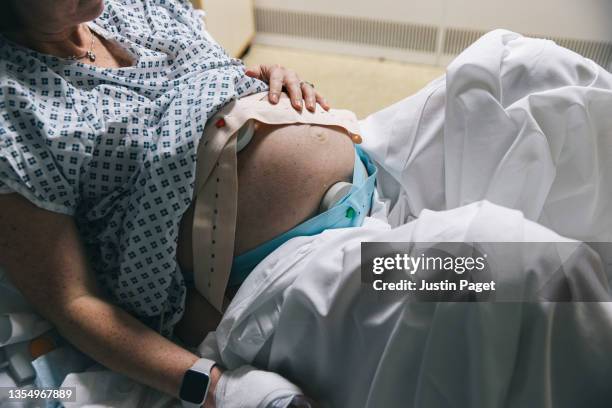 unrecognisable pregnant woman in delivery room getting ready to give birth - giving birth stock pictures, royalty-free photos & images