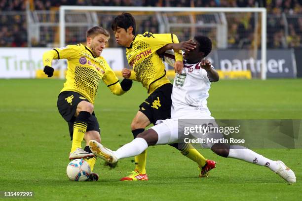 Shinji Kagawa of Dortmund and Rodnei Francisco de Lima of Kaiserslautern battle for the ball during the Bundesliga match between Borussia Dortmund...