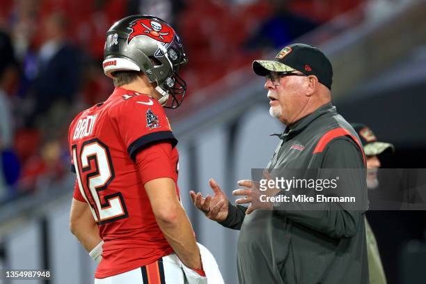 Head Coach Bruce Arians of the Tampa Bay Buccaneers talks with Tom Brady during warm ups before the game against the New York Giants at Raymond James...