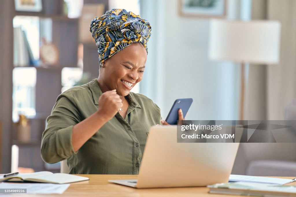 Shot of a businesswoman looking at her smartphone after receiving good news