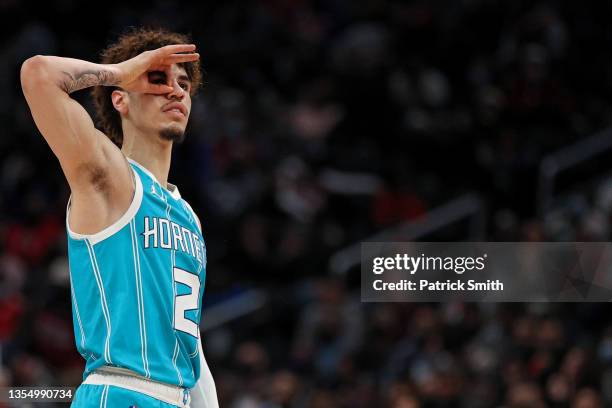 LaMelo Ball of the Charlotte Hornets reacts after shooting a three-pointer against the Washington Wizards during the first half at Capital One Arena...