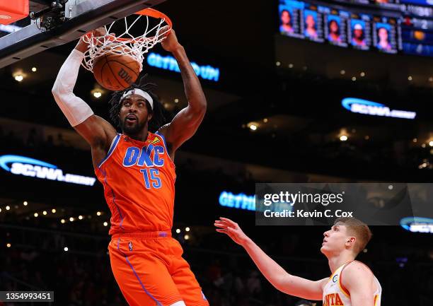 Derrick Favors of the Oklahoma City Thunder dunks against Kevin Huerter of the Atlanta Hawks during the first half at State Farm Arena on November...