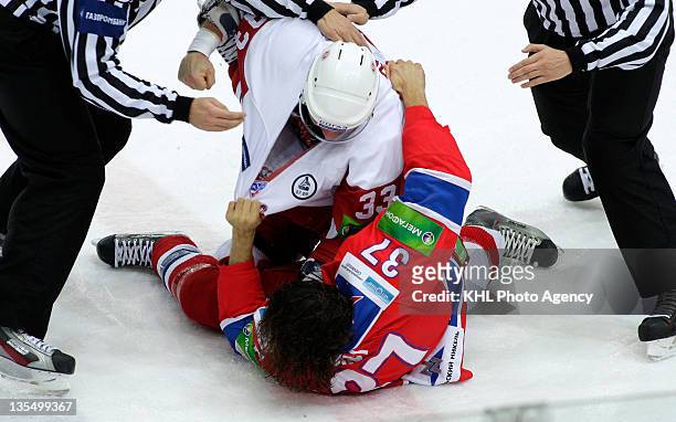 Jeremy Yablonski of the Vityaz and Darsy Verot are tangled up as they fight during the game between Vityaz Chekhov and CSKA Moscow during the KHL...