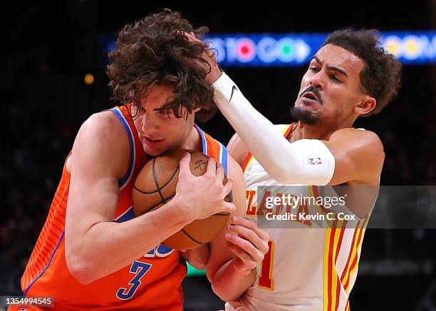 Trae Young of the Atlanta Hawks defends against Josh Giddey of the Oklahoma City Thunder during the first half at State Farm Arena on November 22,...