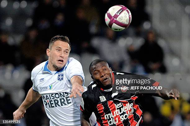 Auxerre's Polish midfielder Dariusz Dudka vies with Nice's Ivorian forward Franck Dja Djedje during the French L1 football match Auxerre vs Nice, on...