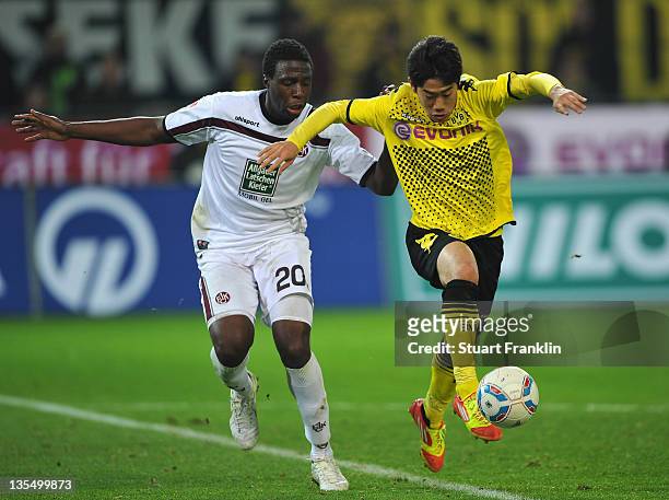 Shinji Kagawa of Dortmund is challenged by Rodnei of Kaiserslautern during the Bundesliga match between Borussia Dortmund and 1. FC Kaiserslautern at...