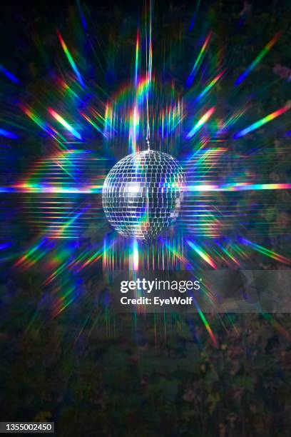 a floating disco ball with reflective psychedelic colors - globe party stock pictures, royalty-free photos & images