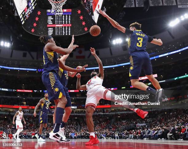 Coby White of the Chicago Bulls gets off a shot against Myles Turner, T.J. McConnell and Chris Duarte of the Indiana Pacers at the United Center on...