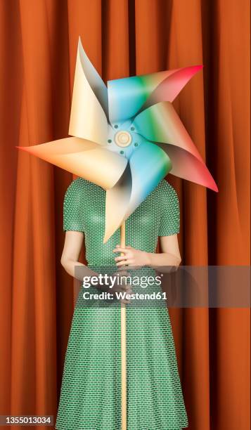 digitally generated image of woman holding pinwheel toy - obscured face stock illustrations