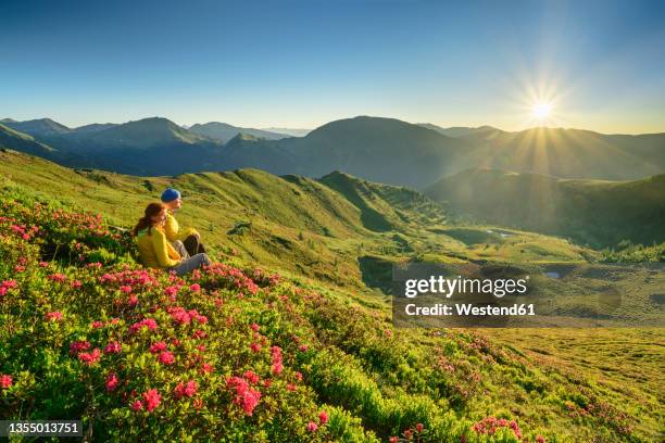 hikers sitting amidst plants at carinthia, austria - carinthia stock pictures, royalty-free photos & images