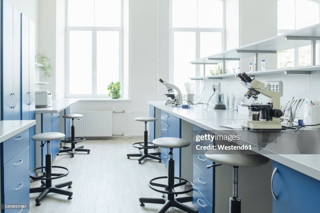 Microscope Desk Microscopes At Desk In Bright Empty Laboratory High-Res Stock Photo ...