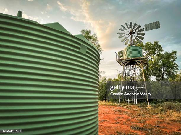 windmill and water storage tanks in rural australia - outback windmill bildbanksfoton och bilder