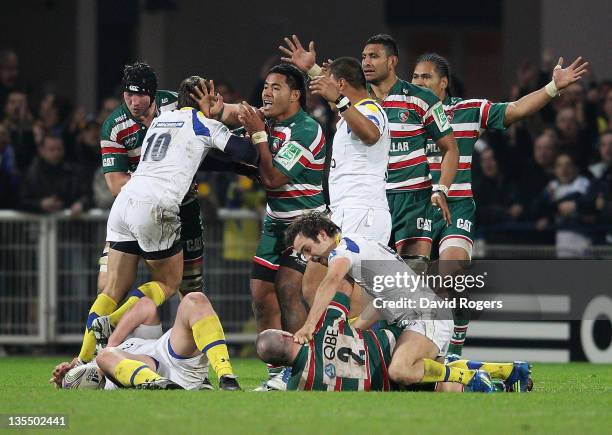 Manu Tuilagi of Leicester is held back by Brock James of Clermont after a tackle on Lionel Faure. George Chuter, the Leicester hooker tustles with...