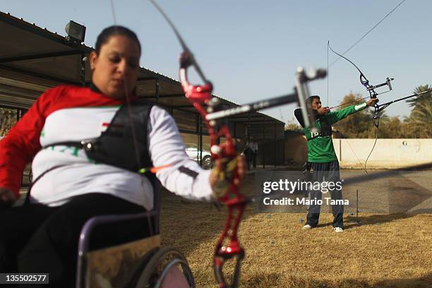 Disabled athletes Mustafa Muhammed and Rana Alawi practice archery as they train for the Paralympic team at the Al Thura Sports Handicapped Club...