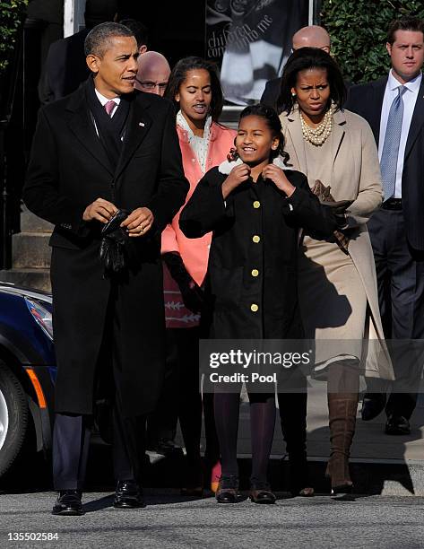 President Barack Obama, first lady Michelle Obama and daughters Malia Obama and Sasha Obama walk from St. John's Church to the White House after...