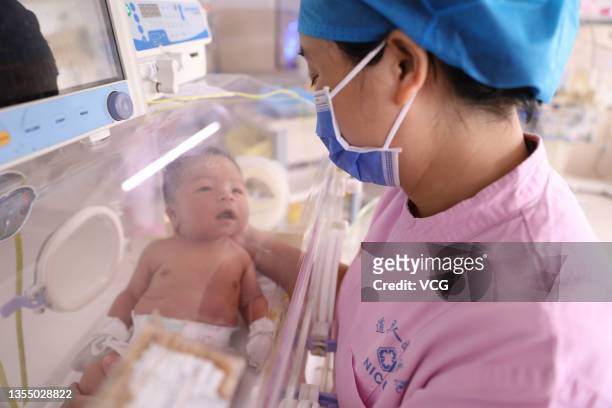 Nurse takes care of a newborn baby in an incubator at a hospital on October 4, 2021 in Daoxian County, Yongzhou City, Hunan Province of China.