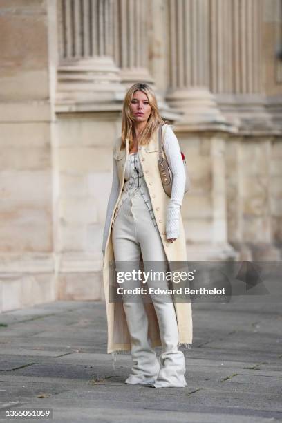 Natalia Verza wears a white latte embossed wool pattern buttoned long cardigan, a matching white latte embossed wool pattern buttoned short jacket, a...