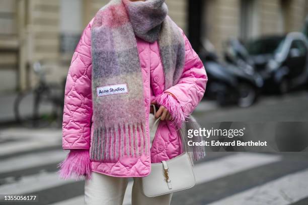 Katie Giorgadze @katie.one wears a pink knitted mohair sweater with feather sleeves from Eleonora Gottardi, a pink / gray / purple checkered print...