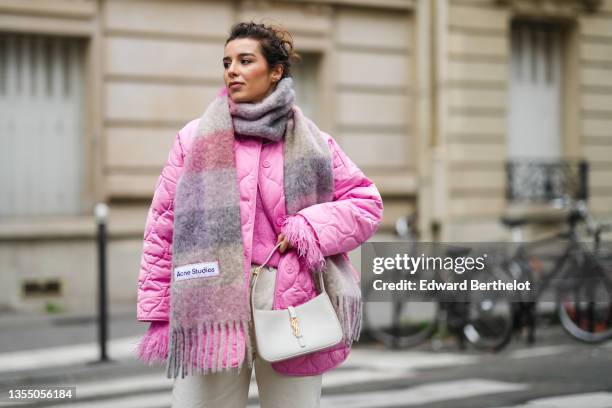 Katie Giorgadze @katie.one wears a pink knitted mohair sweater with feather sleeves from Eleonora Gottardi, a pink / gray / purple checkered print...