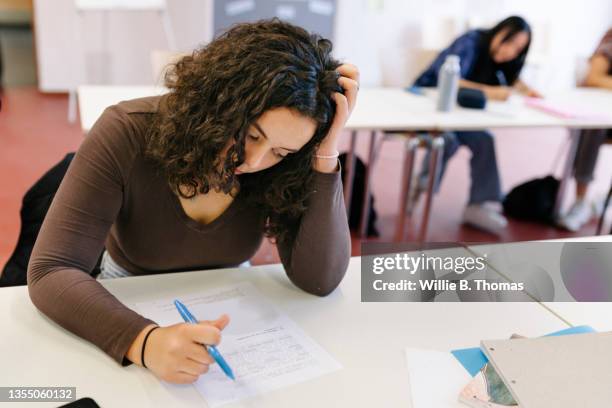 student having hard time during test - educational exam stock pictures, royalty-free photos & images