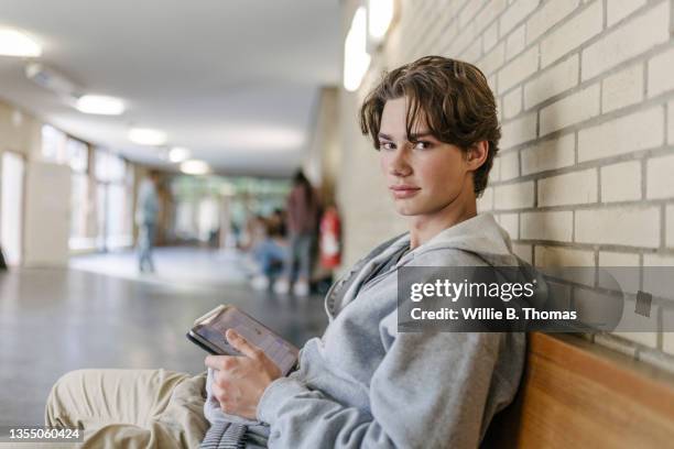 portrait of student sitting on bench - digital native stock pictures, royalty-free photos & images