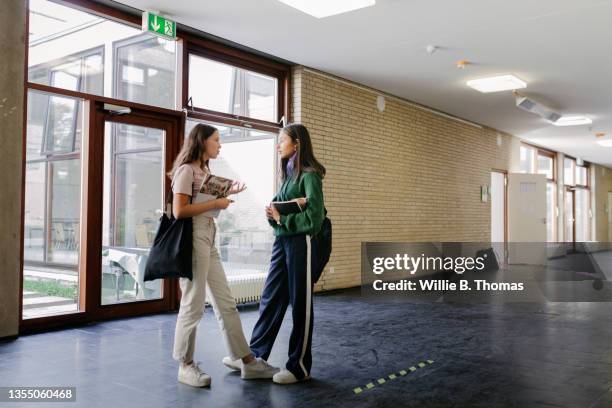 two high school students chatting in hallway - study hall stock pictures, royalty-free photos & images