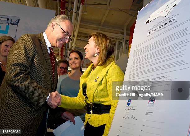 In this handout provided by NASA, U.S. Sen. Charles Schumer and NASA Deputy Administrator Lori Garver shake hands after they signed the transfer of...