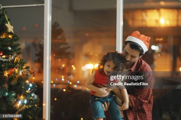 cheerful father holding daughter flying in air enjoying on christmas night. - dad throwing kid in air imagens e fotografias de stock