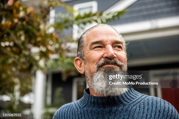 portrait of senior man in front of suburban home - baby boomer fotografías e imágenes de stock