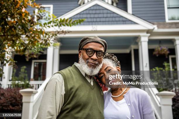 portrait of senior husband and wife in front of suburban home - pearl district stock pictures, royalty-free photos & images