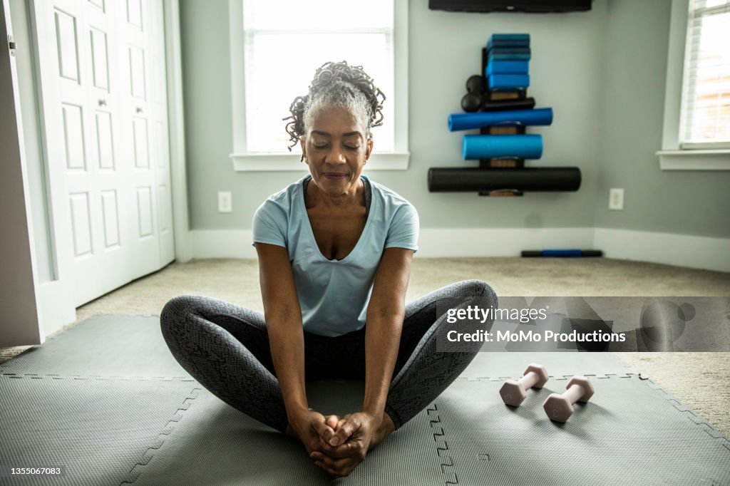 Senior woman exercising in home gym