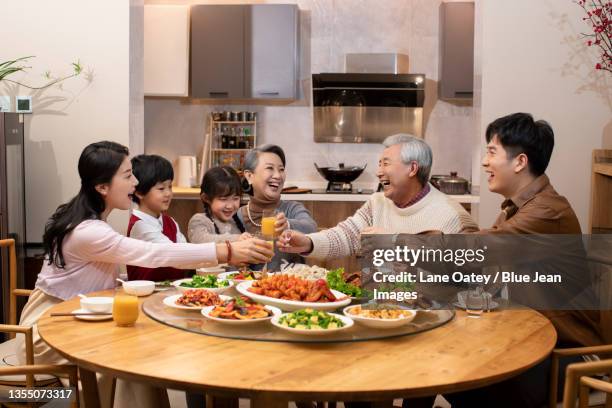 happy family having chinese new year dinner - wiedersehenstreffen stock-fotos und bilder